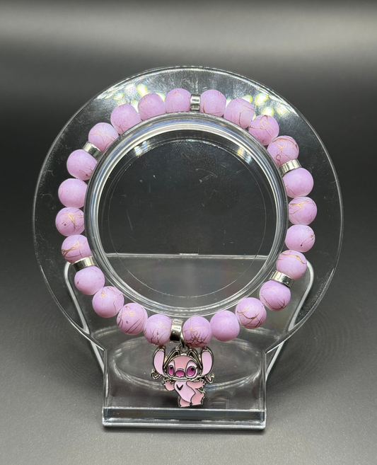 Pink beaded bracelet with a pink Angel (Lilo & Stitch) charm on a clear stand against a gray background